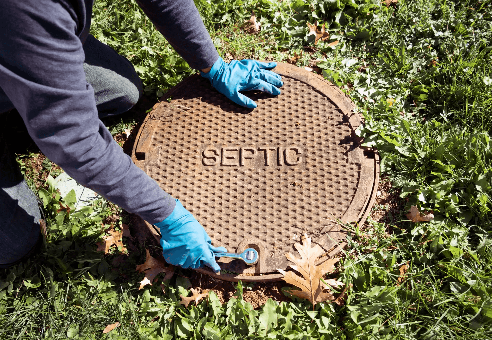 Image of someone opening a septic tank for a septic tank pump out