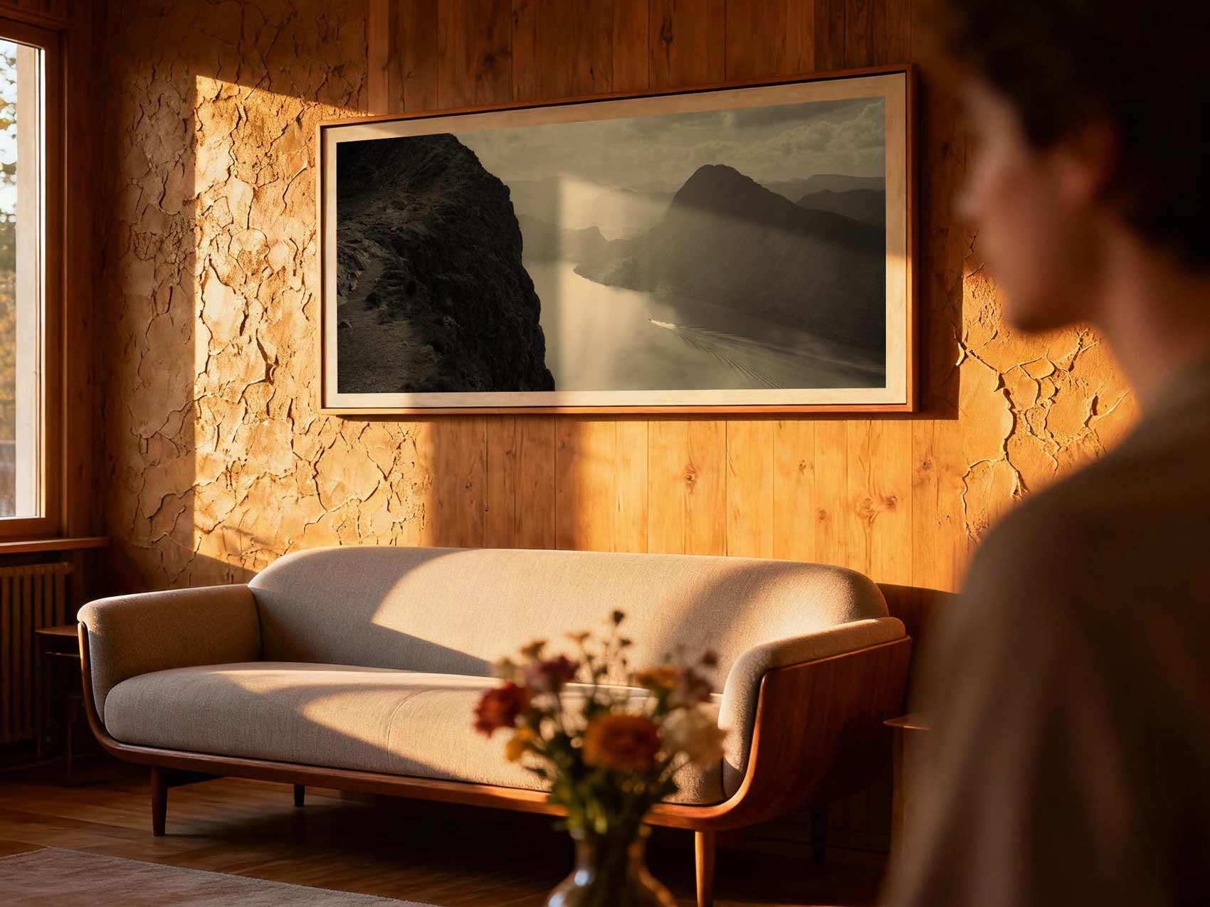 A panoramic photo of a black and white landscape on the wall above the sofa in the living room