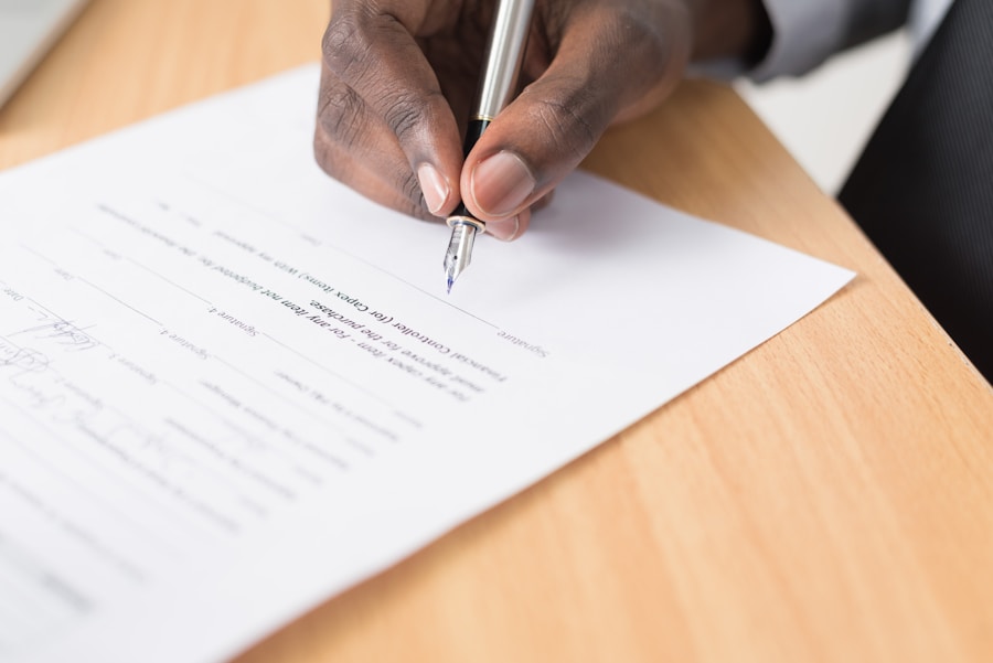A hand signing a contract with a fountain pen