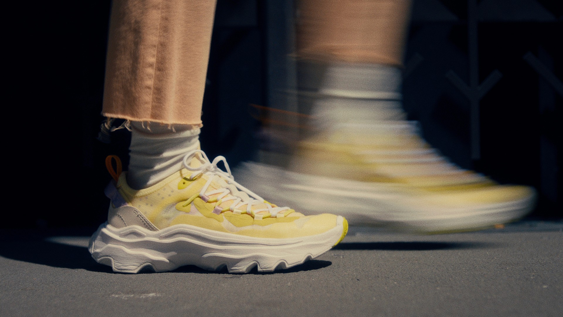 Yellow Sorel sneakers in motion
