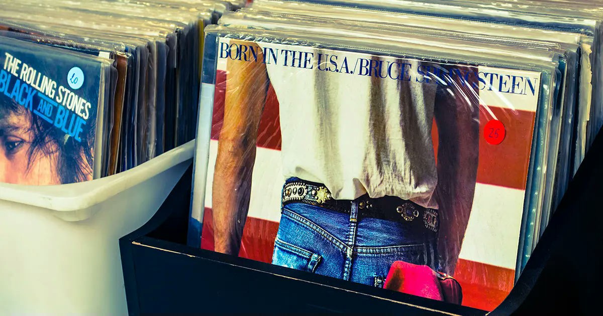 Vinyl records in a store bin, featuring Bruce Springsteen’s ‘Born in the U.S.A.’ album cover.