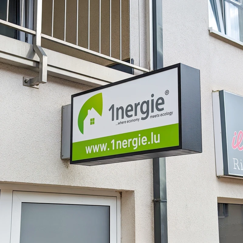 Exterior building lightbox sign for '1nergie' green logo