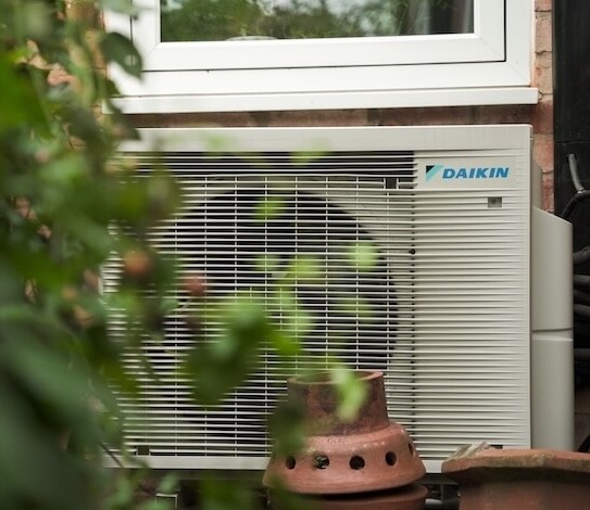 Heat pump outside front of house.