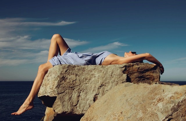 A woman receives a relaxing energy healing in a serene setting with soft lighting.
