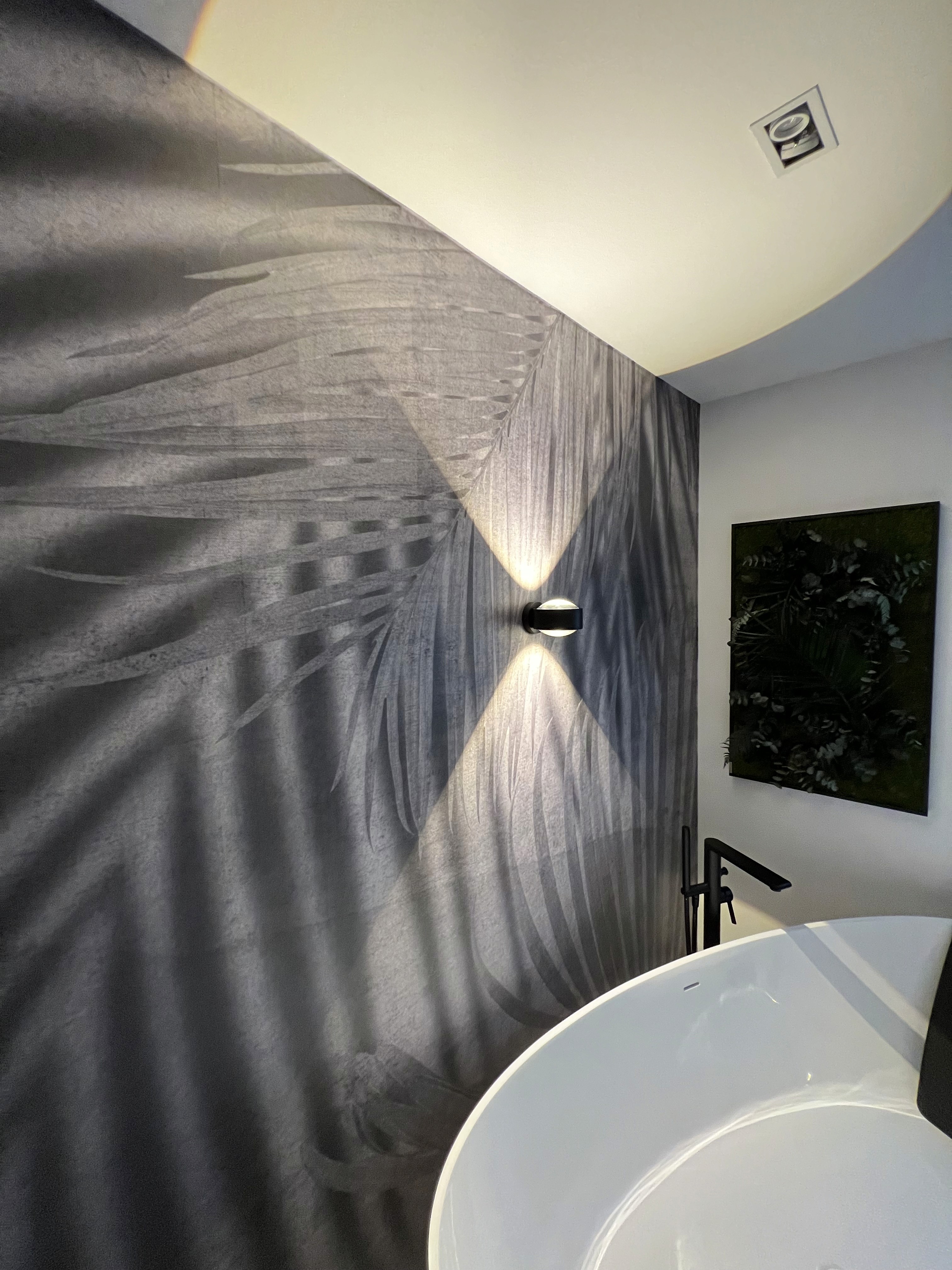 A bedroom with a bed and a night stand