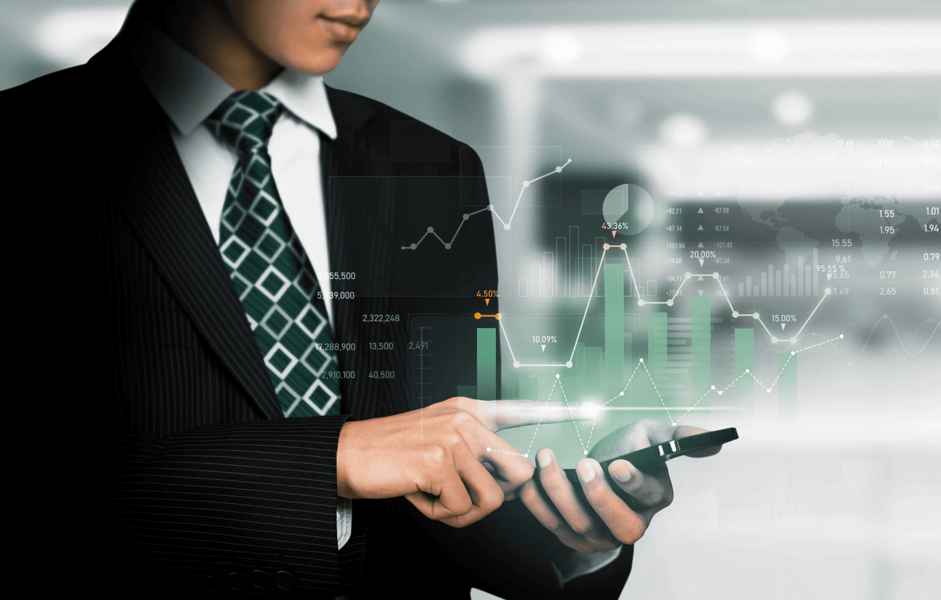 a group of people sitting around a table with laptops