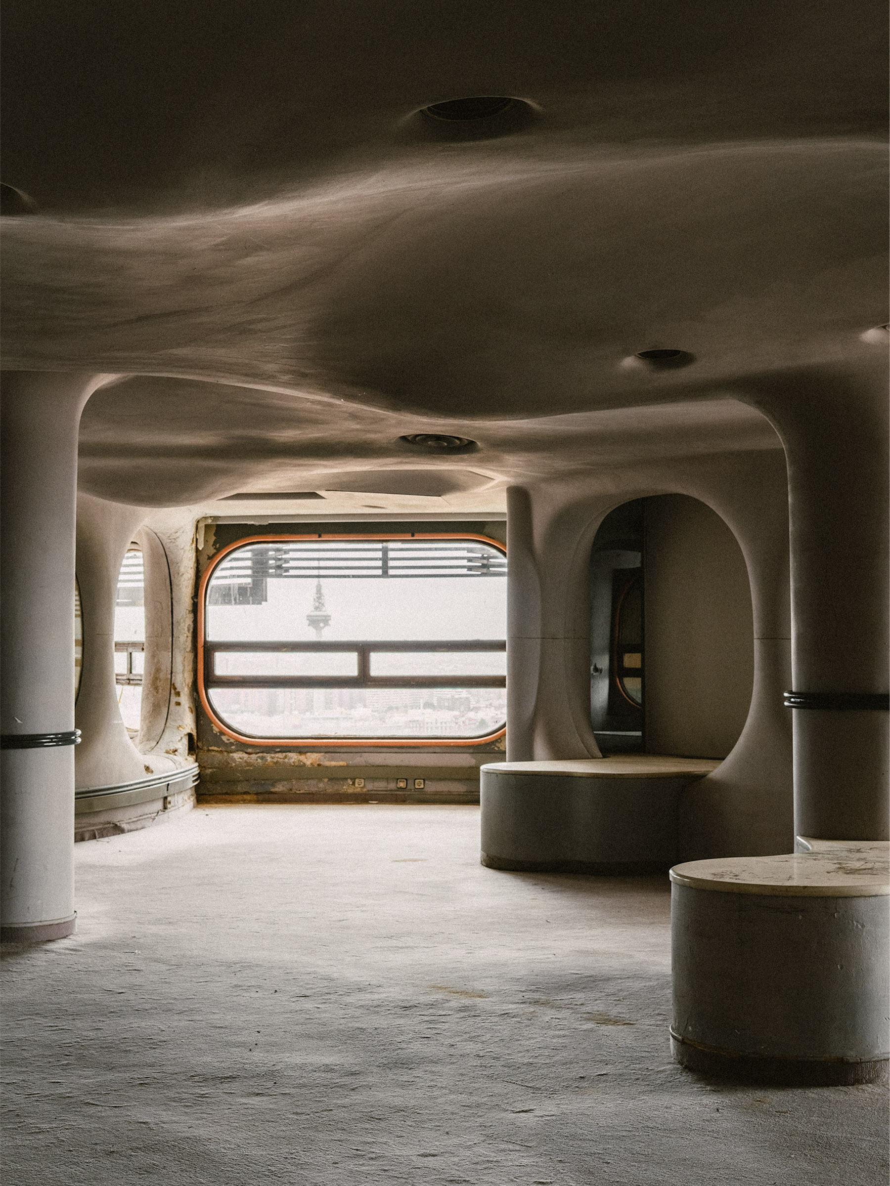Interior view of the 22nd floor of Torres Blancas in Madrid, showing its curved Brutalist architecture.