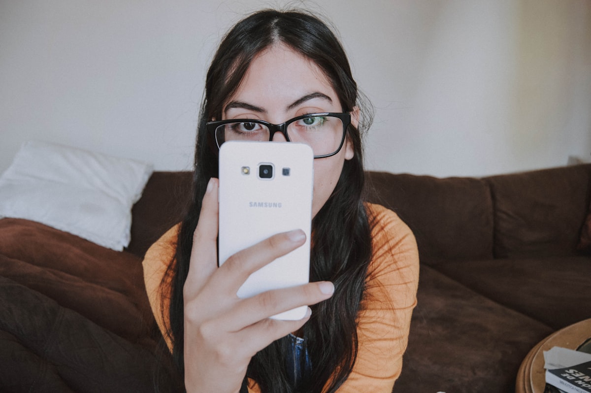 Person scrolling travel inspiration on a phone while deciding where to go