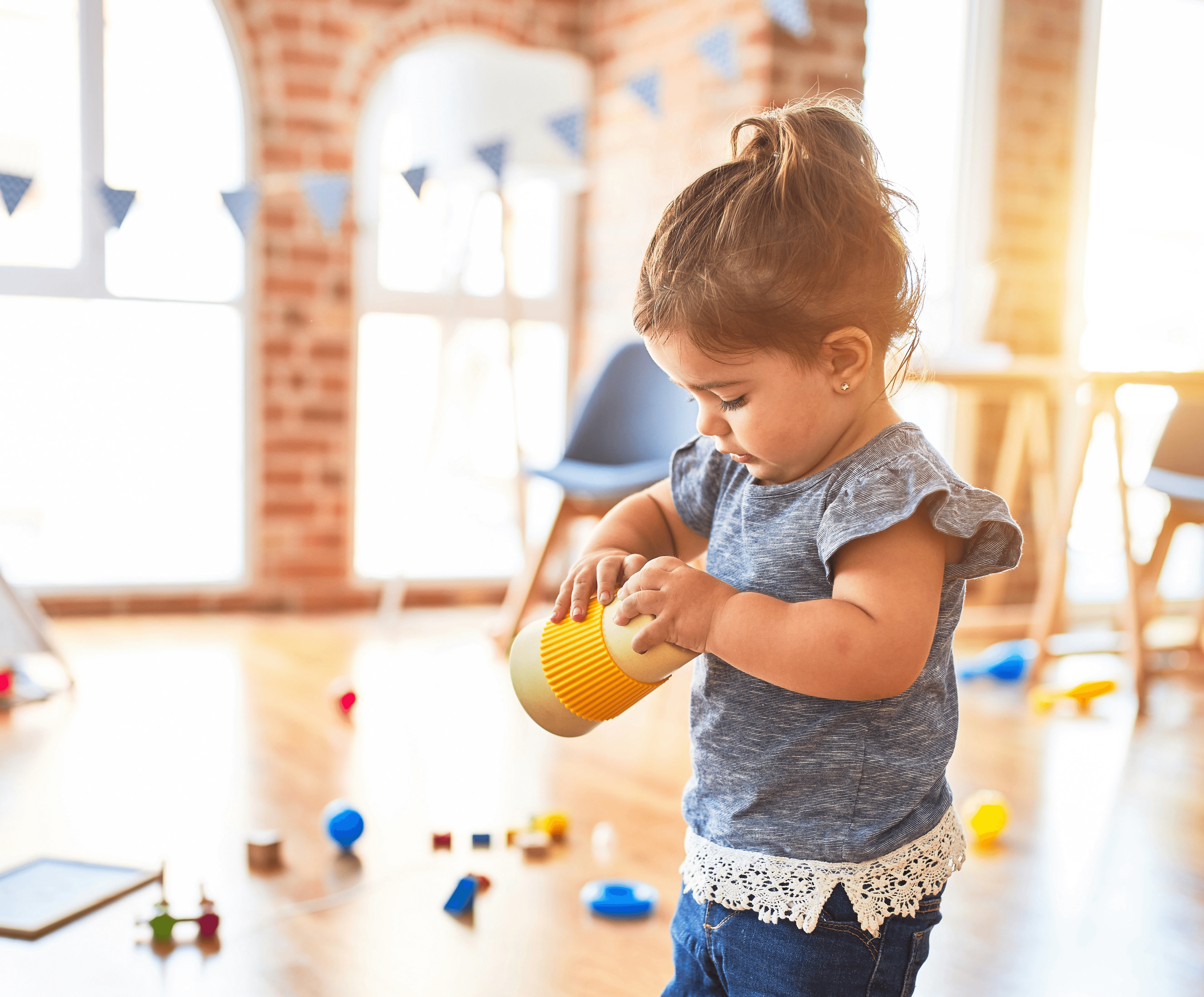 girl in blue denim dungaree pants holding blue and white polka dot handbag