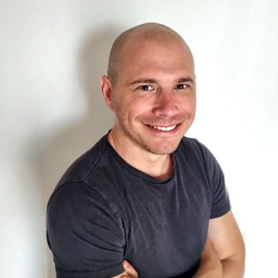 man sitting on gray concrete wall