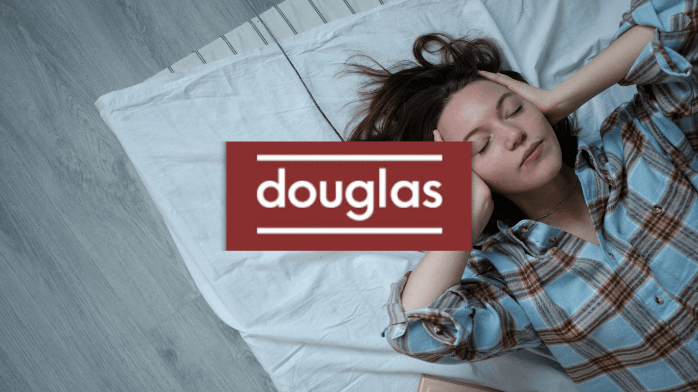An overhead view of a person on a white bedsheet holding their head, suggesting stress or exhaustion. The red Douglas logo is centered over the image in a red block, serving as the main header image for the newcomer mattress guide.