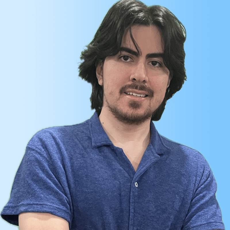 A person in a blue coat smiling