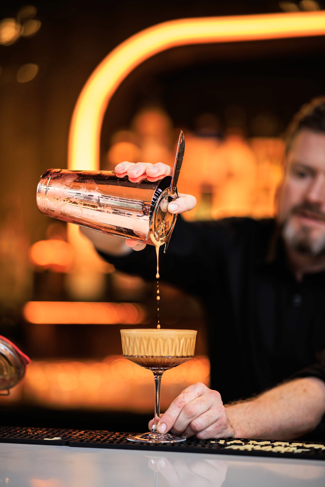 Bartender pouring Salted Caramel Espresso Martini at Her Upstairs