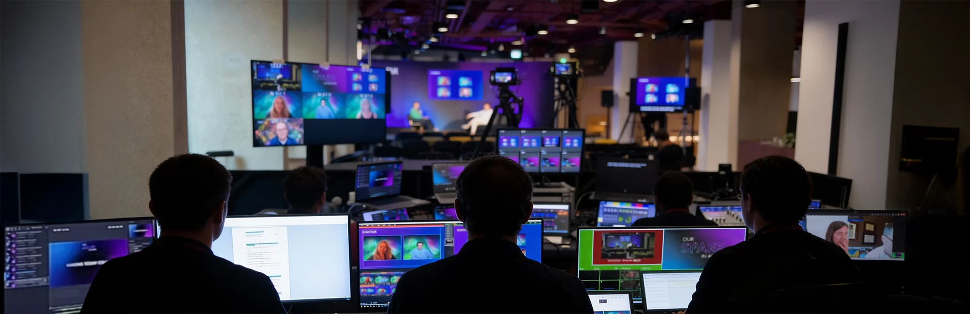 Production team managing a multi-camera live stream from a control desk during a studio broadcast