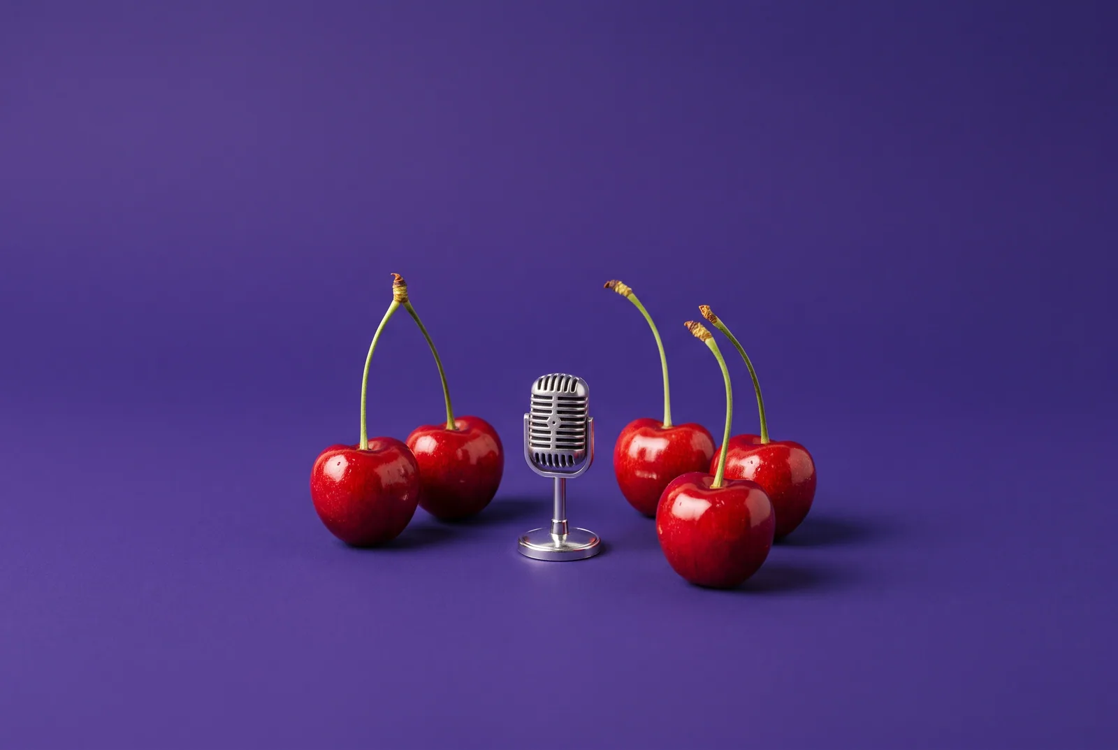 Five cherries gathered around a tiny vintage microphone, what real users say in QUITTR vs Relay