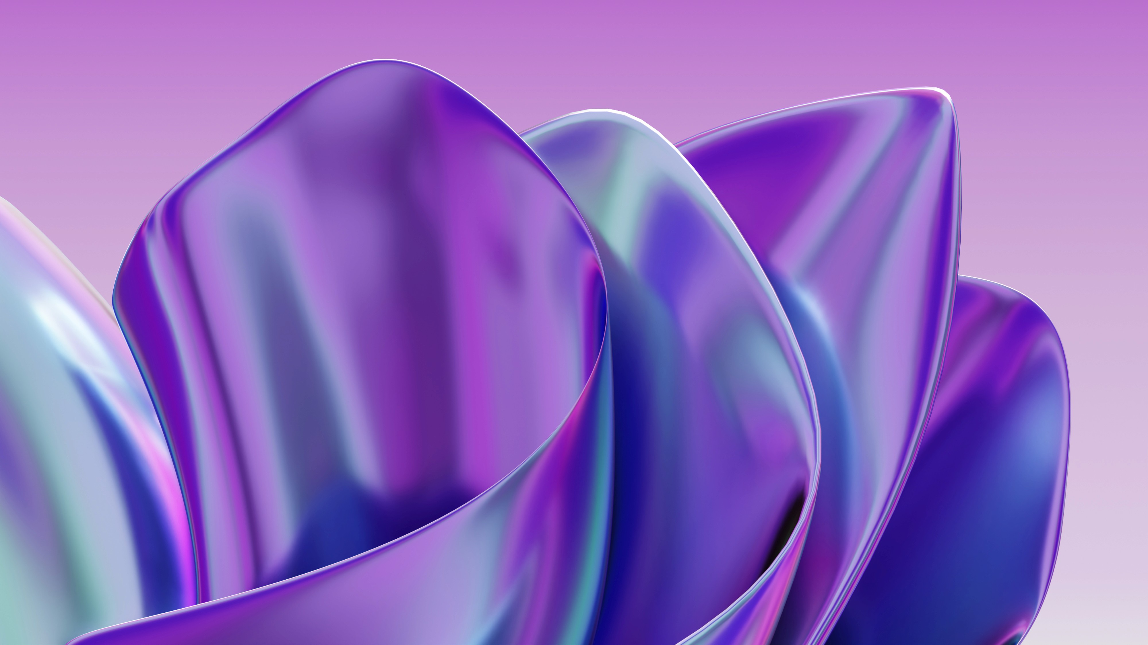 Woman working on a laptop computer at a table in a bright room.