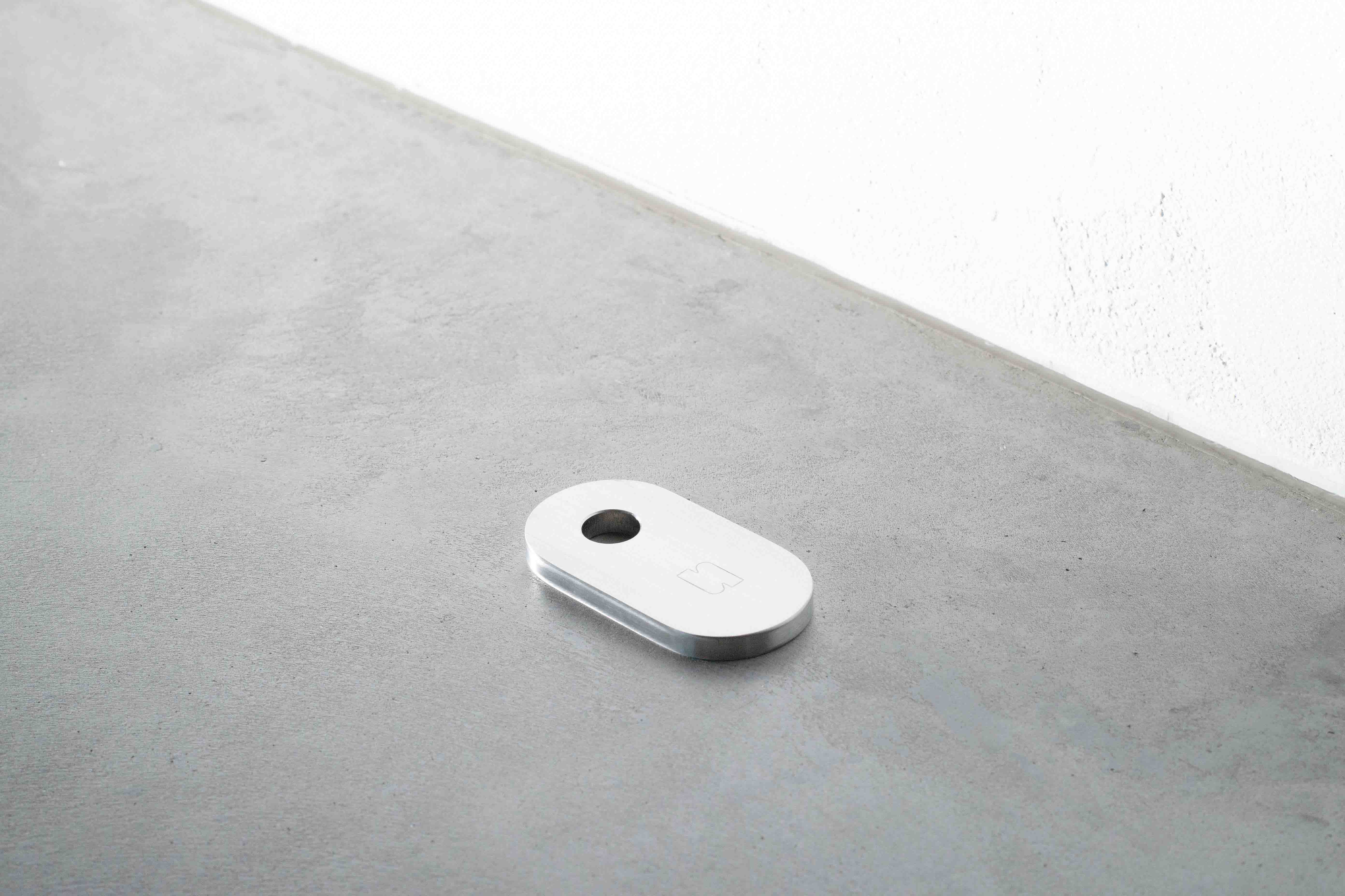 sideview of a metal candle holder on a concrete floor