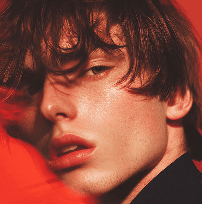 Asian woman in white turtleneck sweater with eyes closed