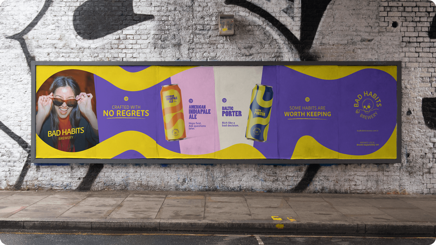 Billboard mockup under an urban brick archway displaying vibrant purple and yellow branding, beer cans, and typography for Bad Habits Brewery case study.