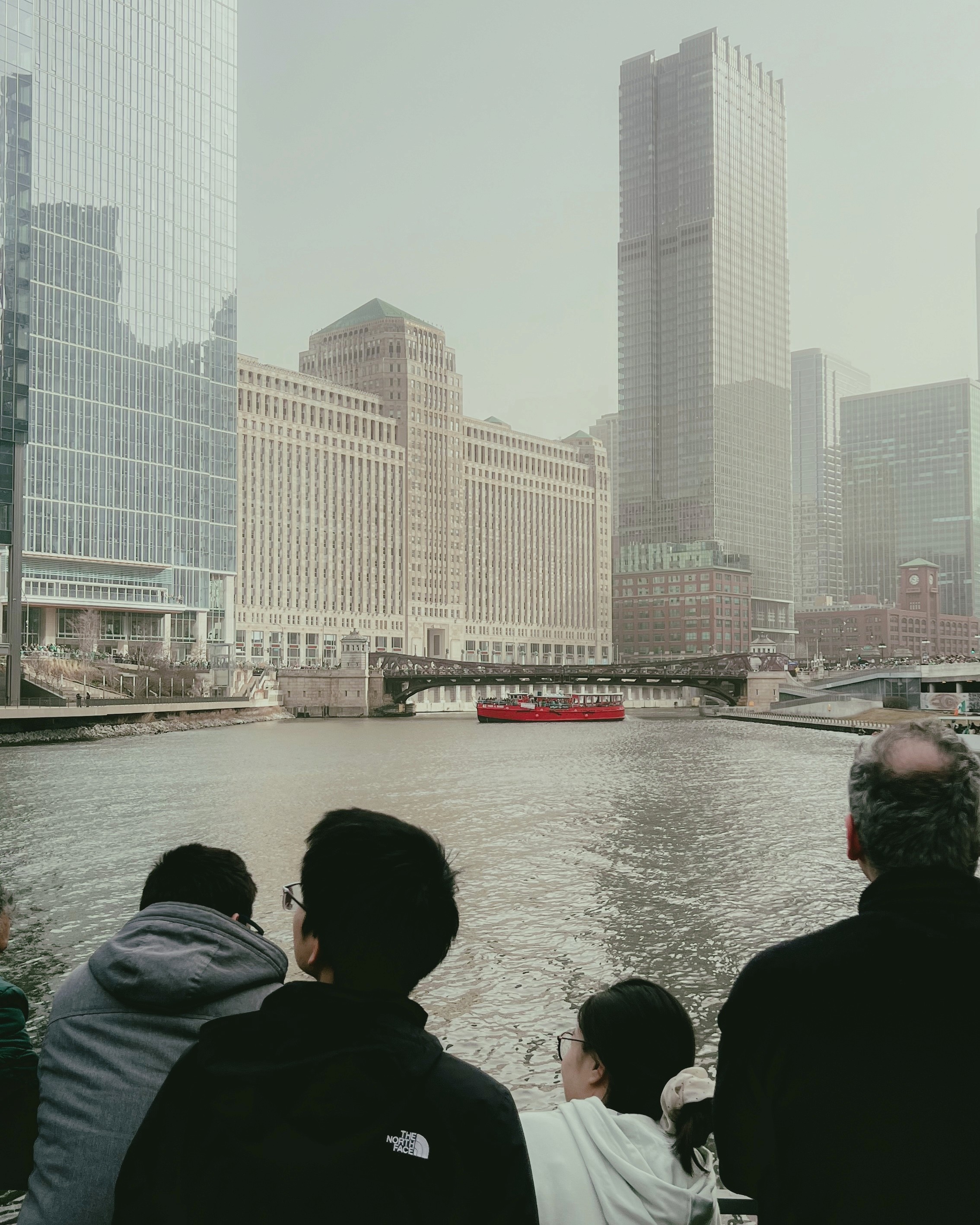 Two people talking on a rooftop at sunset
