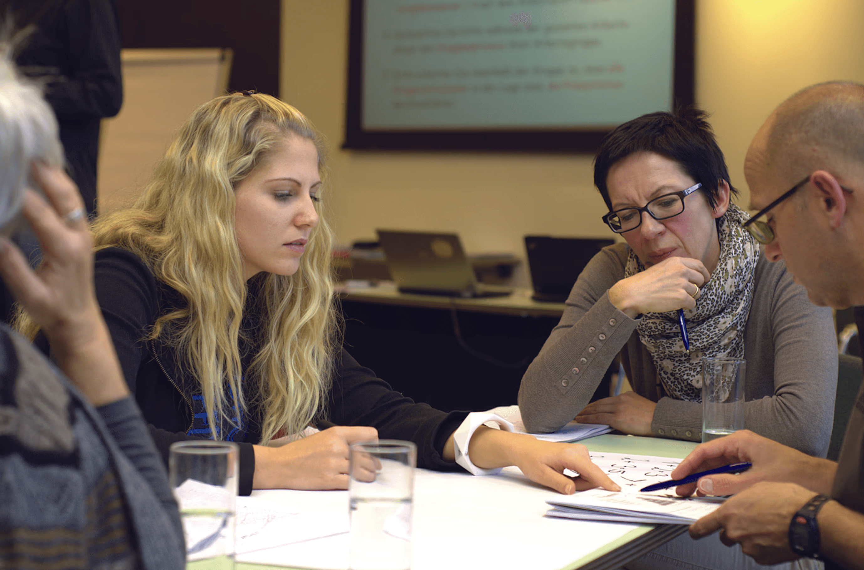 boy and girl standing near window looking outside