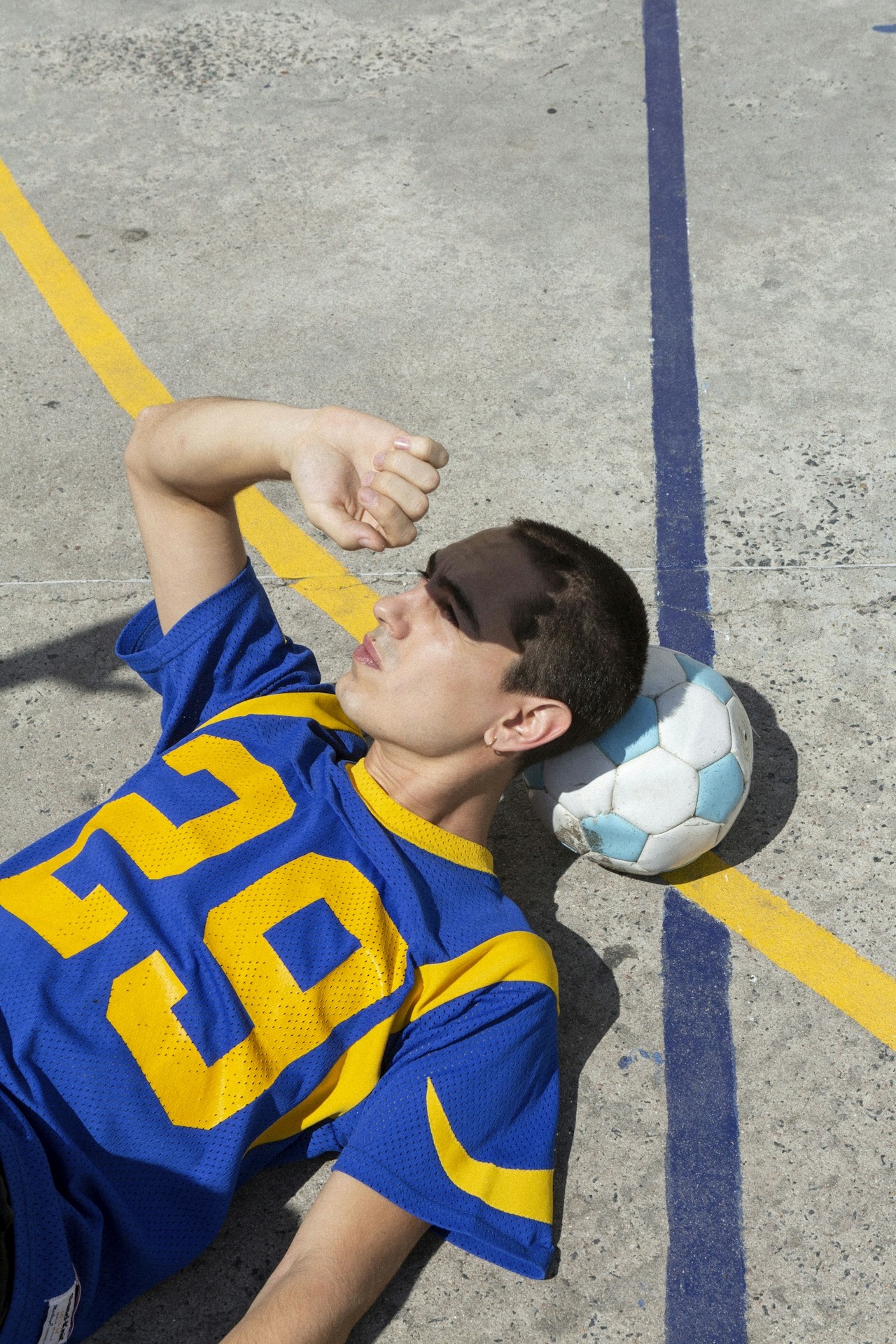 Two colleagues collaborating over paperwork at an office desk, with plants in the background.