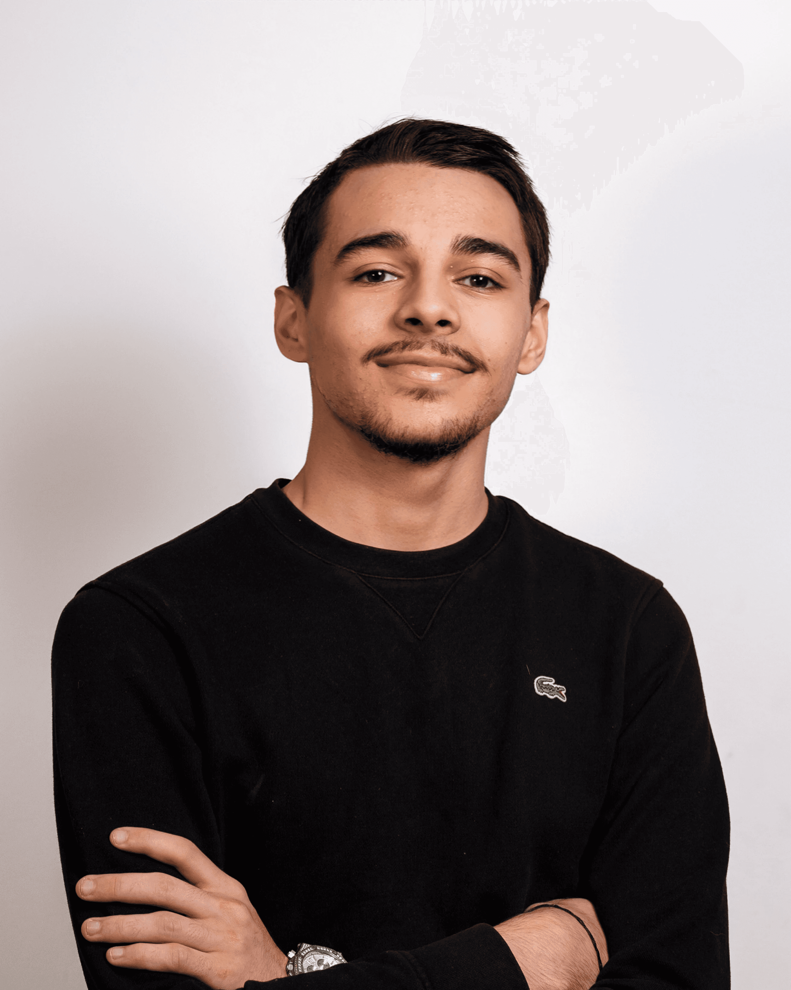 Portrait of a person in a pink sweater against a light background