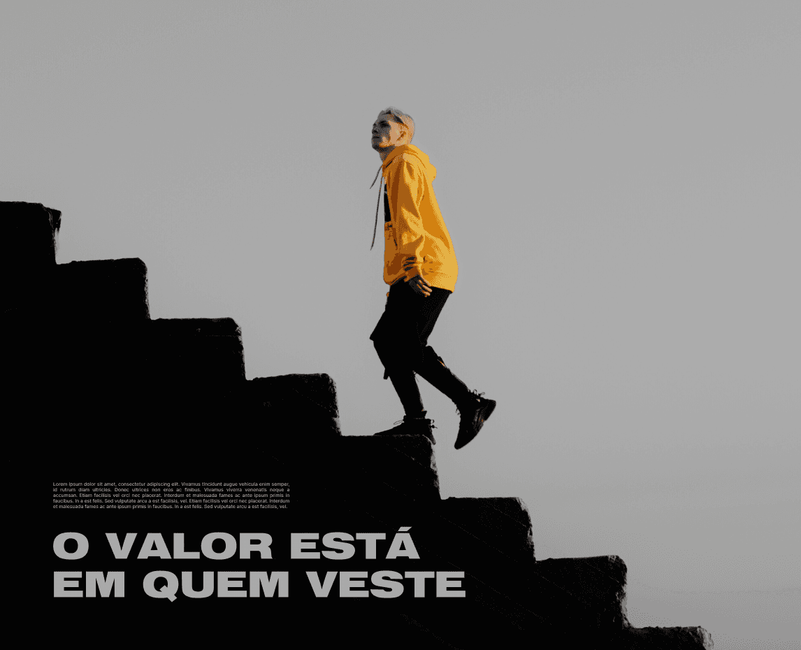 A modern green chair with a curved design and dark wooden legs against a dark background.