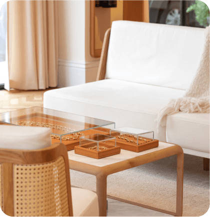 Stylish living room featuring a white sofa, minimalist coffee table with gold accents, and warm lighting, showcasing Click Media Group’s property photography expertise