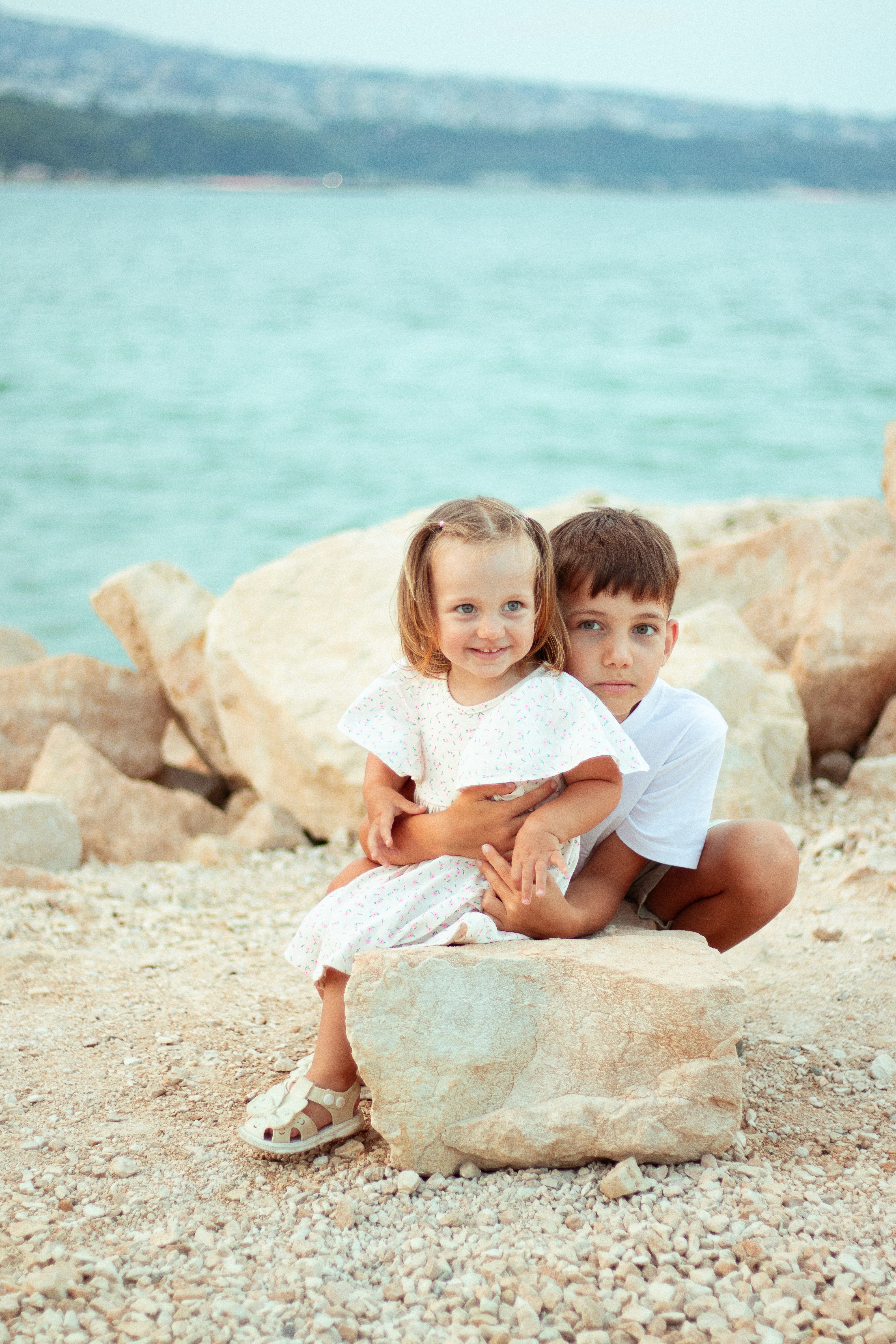 woman holding baby beside man smiling