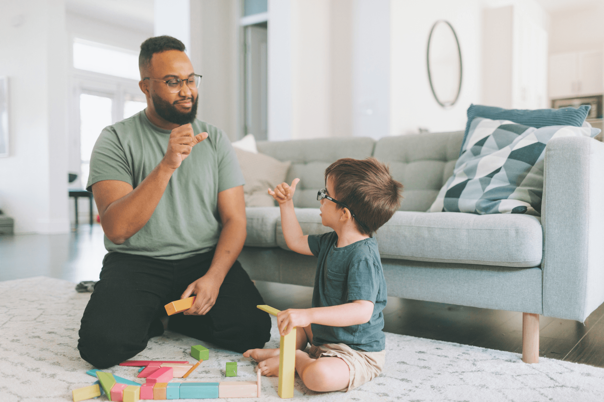 A man is playing with a child in a room