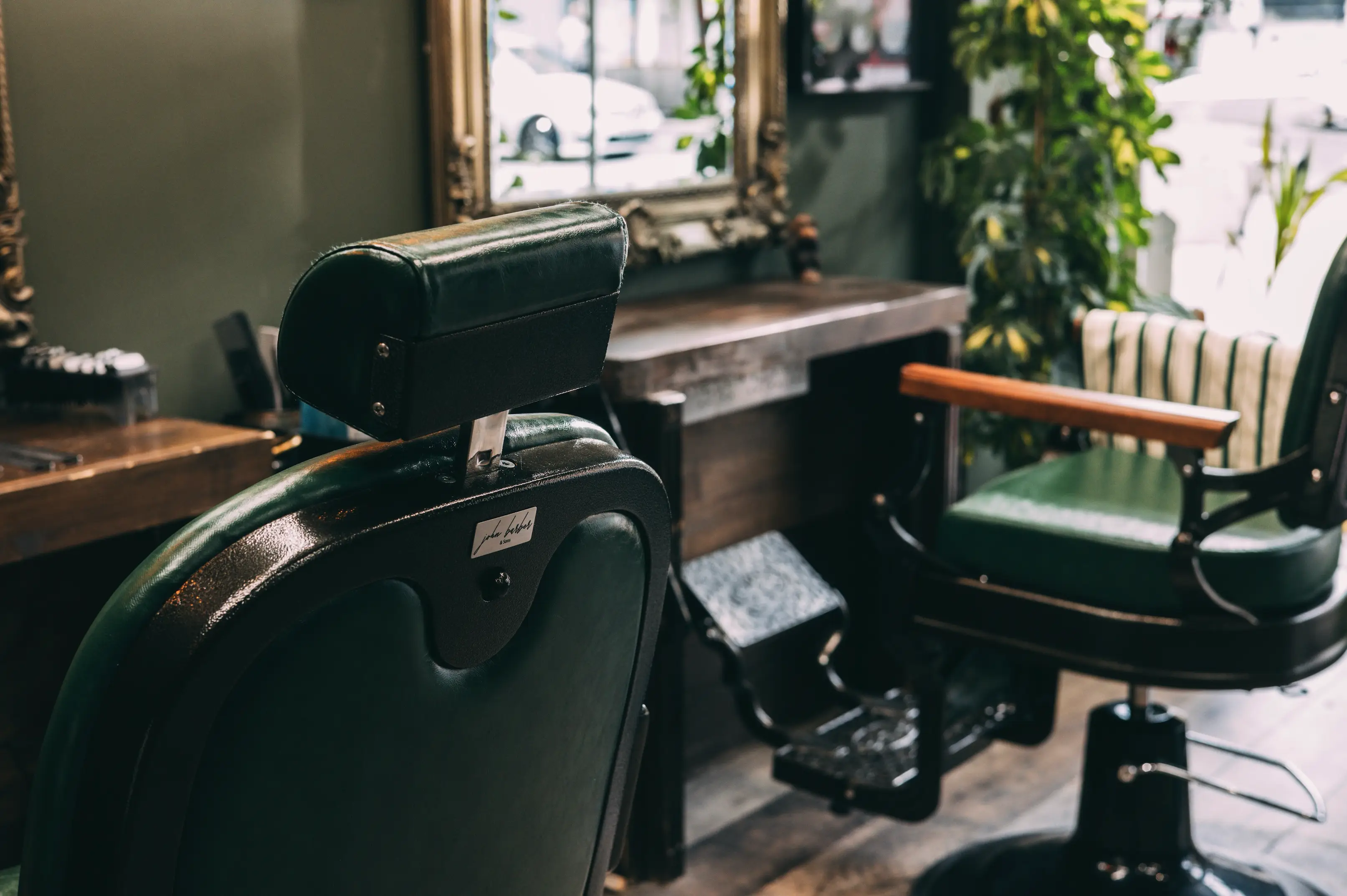 Interior shot of a green Botanical themed barber shop.