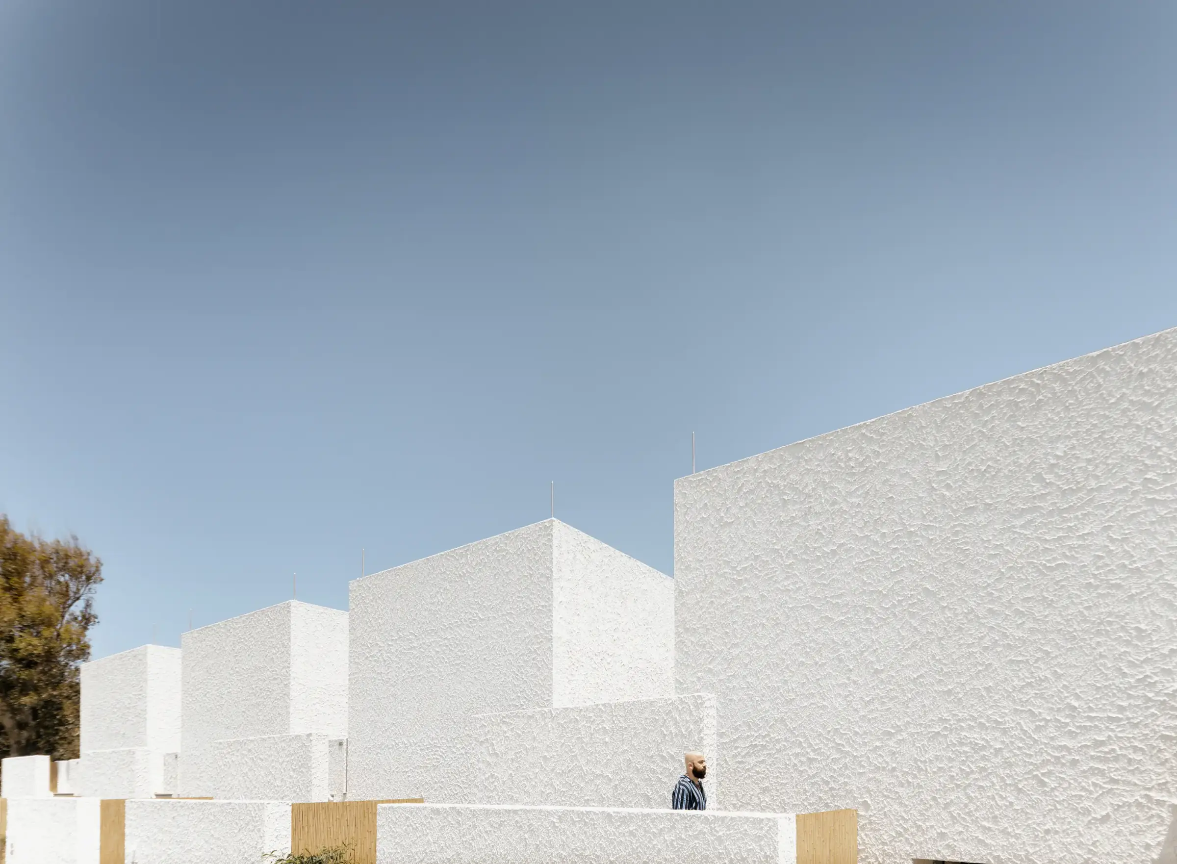 Stepped white volumes against the sky