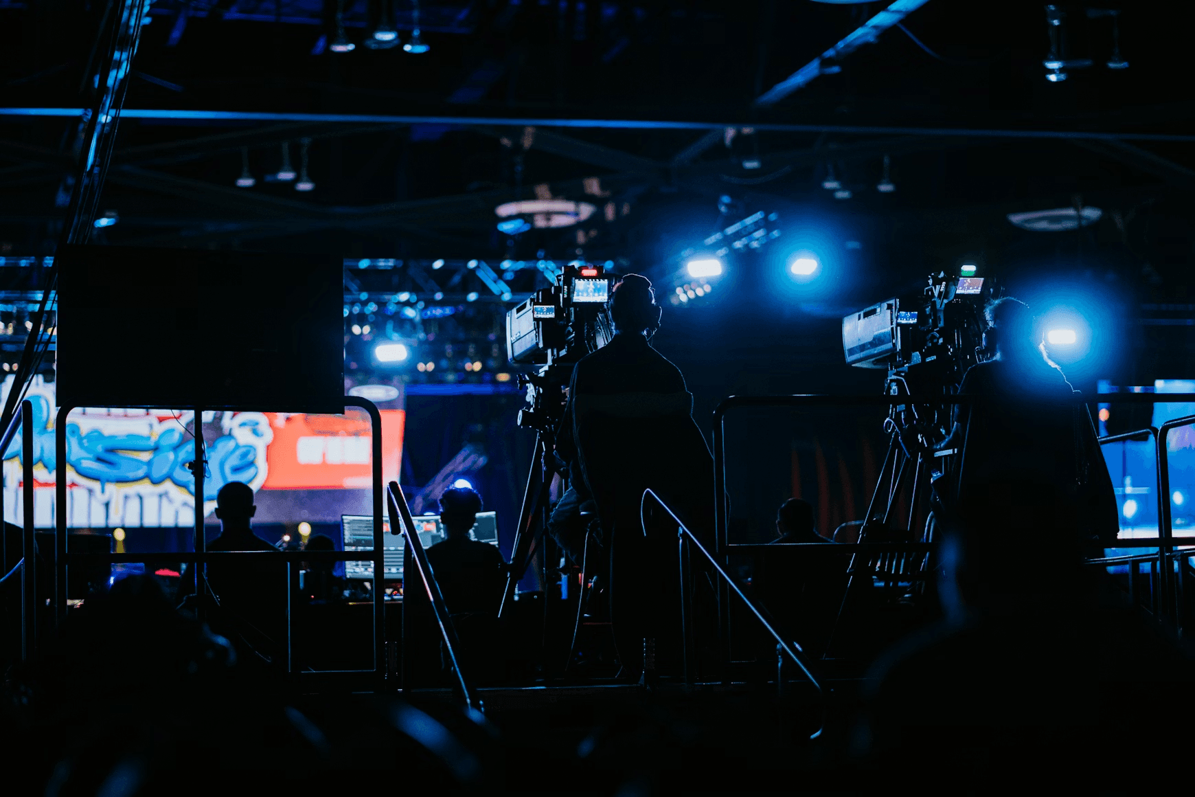 Crew filming a live event with studio cameras