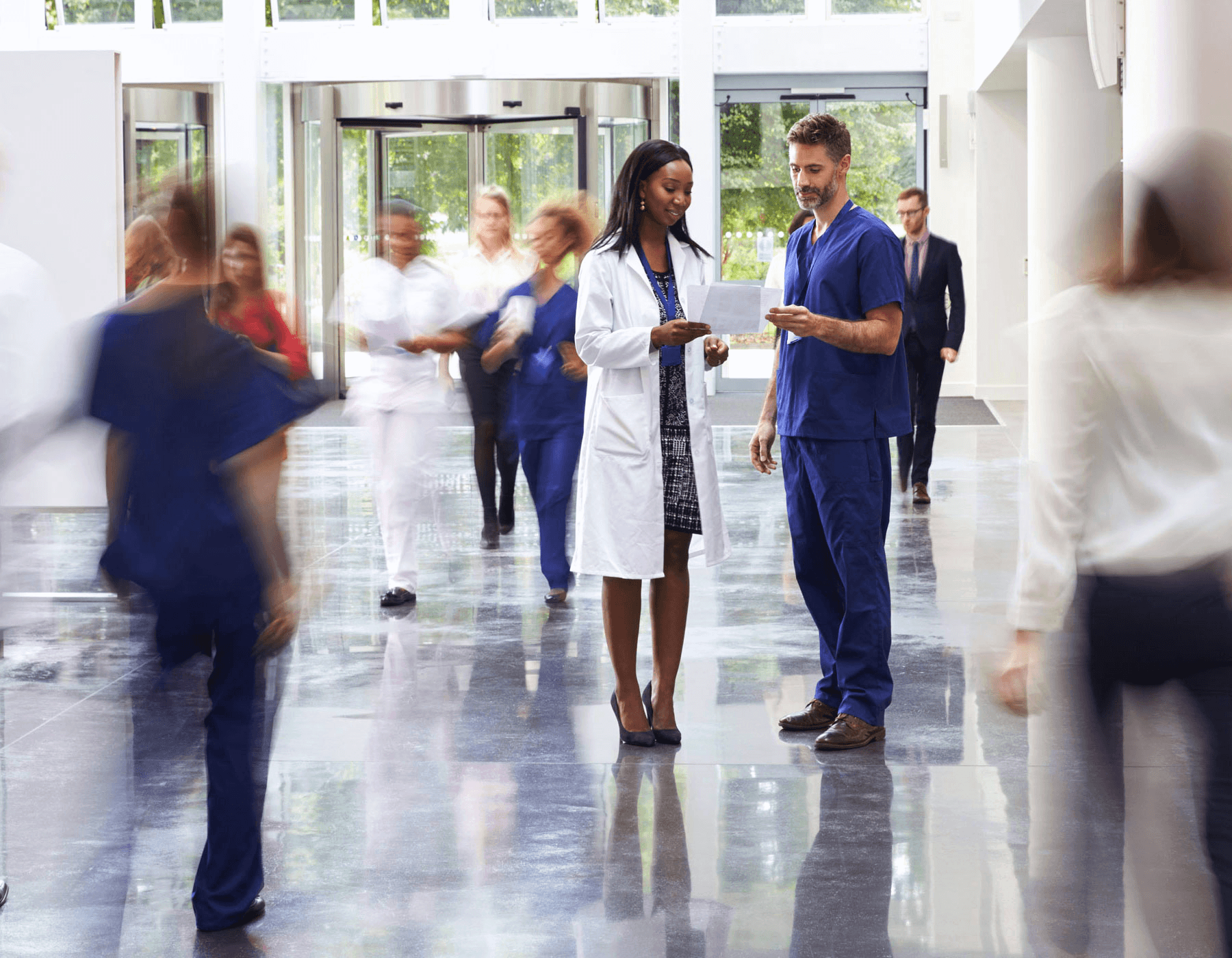 Locum physicians walking through hospital hallway before shift