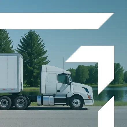 White semi-truck parked near a lake with trees in the background — representing GIA Group, LLC’s Excess and Umbrella Liability Insurance.
