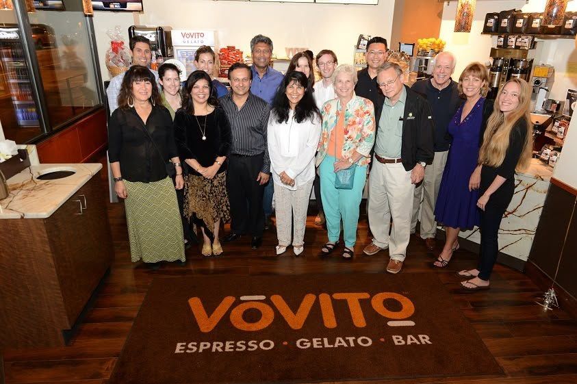Vovito Cafe Opening Day in Seattle. People standing in a room with decorations and pictures.