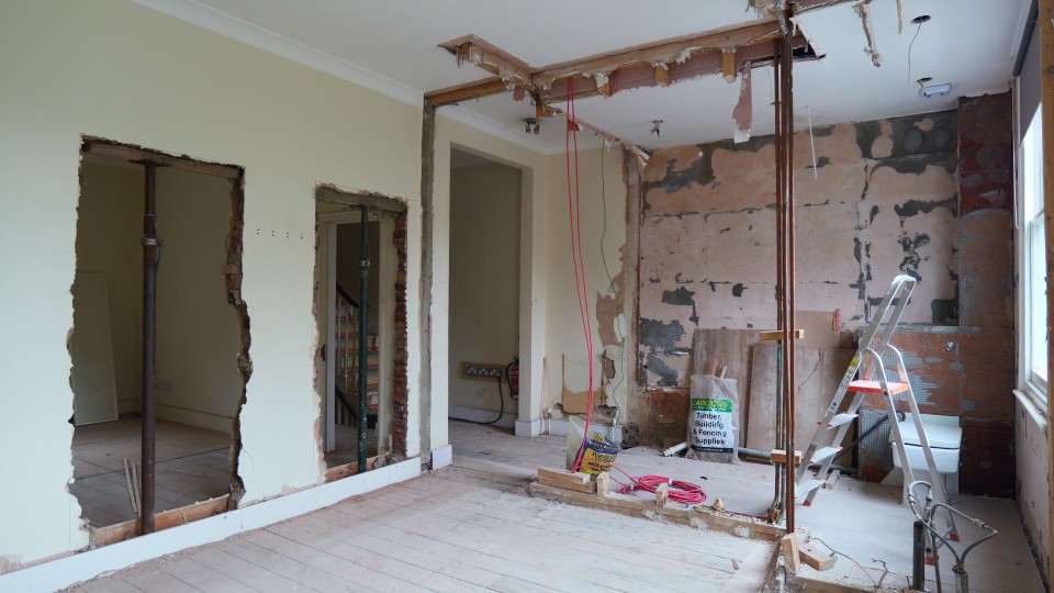 HMO property refurbishment with wall openings, exposed pipework and strip out works