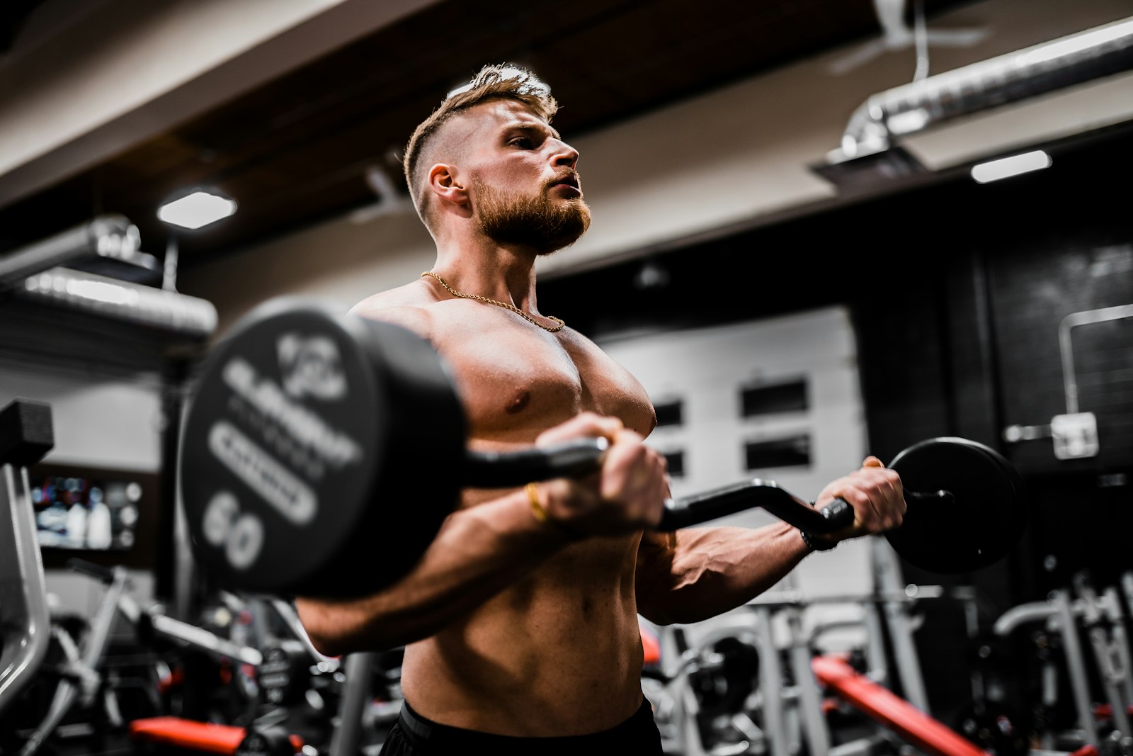 Person using a wall-mounted strength training device