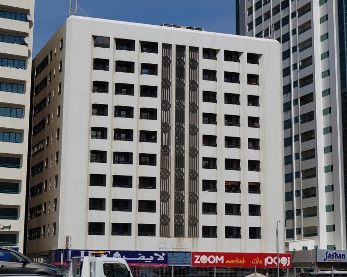 Exterior view of White Swan Building with retail shops, managed by expert real estate agents in Dubai.