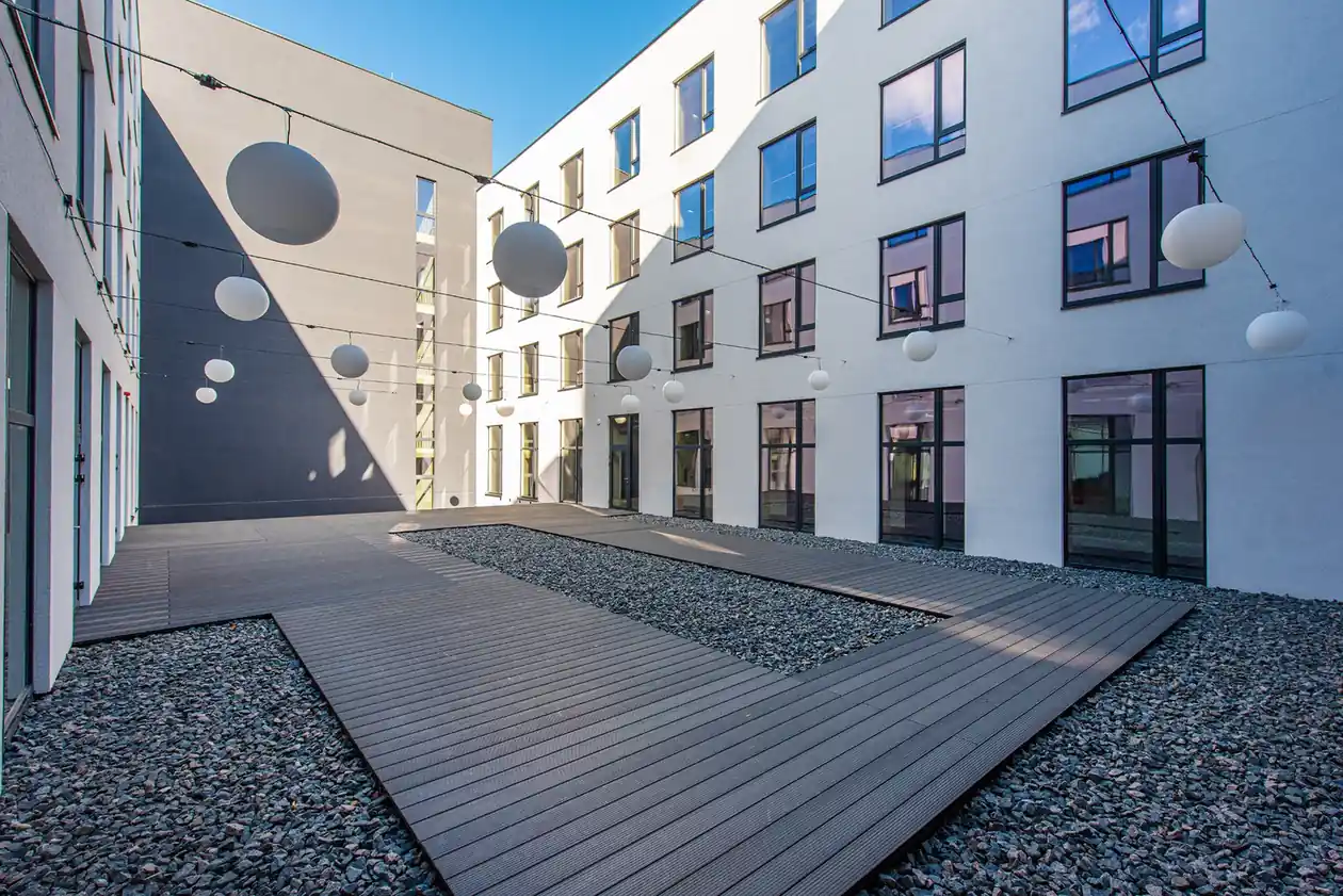 Private courtyard at student accommodation in Vilnius with outdoor walkways and modern architecture.