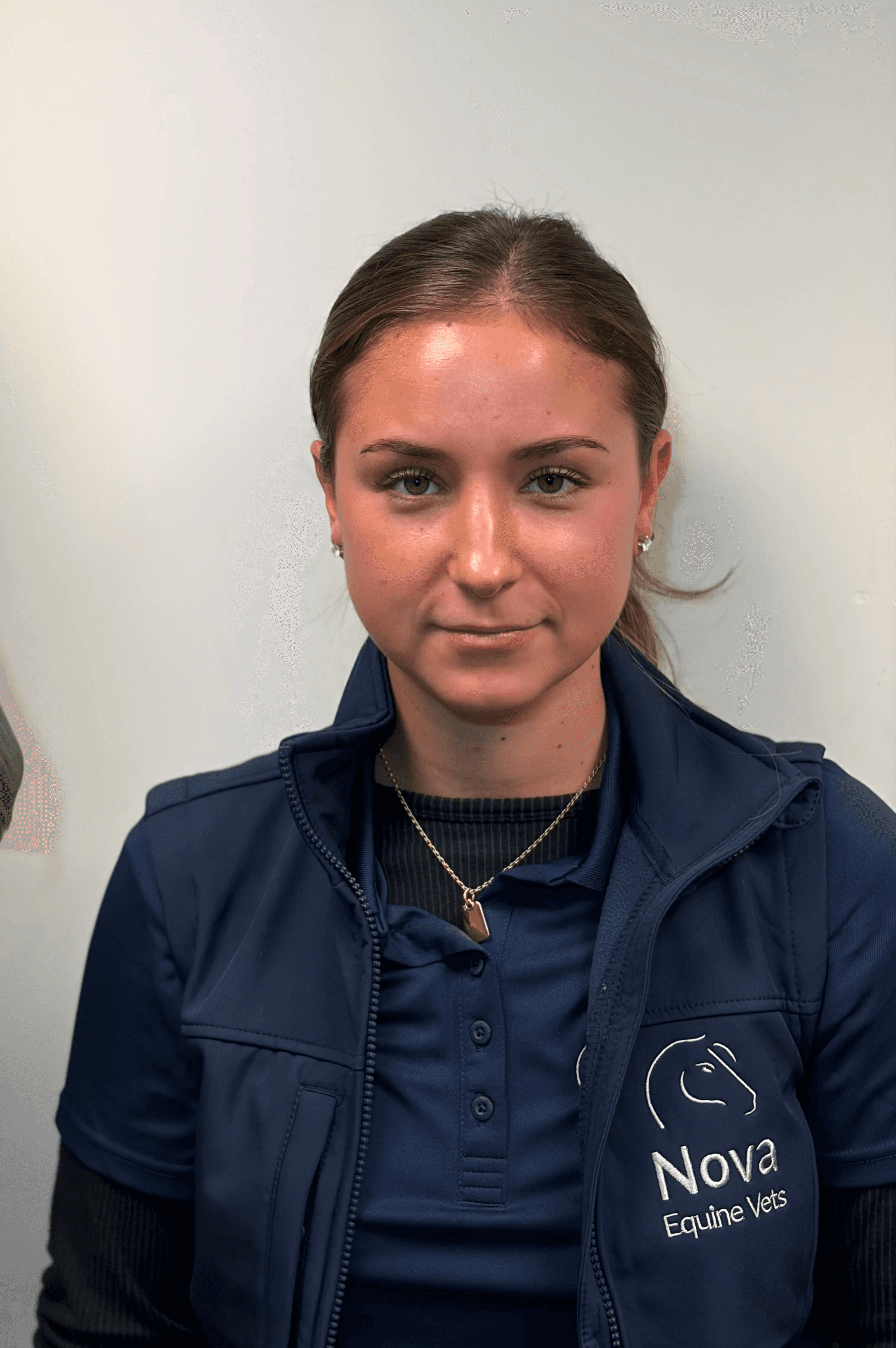 a man in a blue shirt smiling at the camera