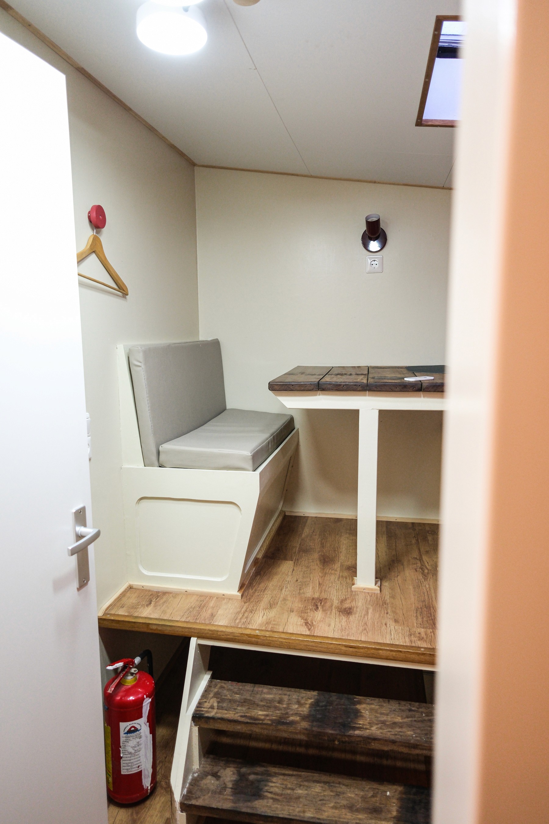 Gray sectional sofa with black coffee table and blue rug