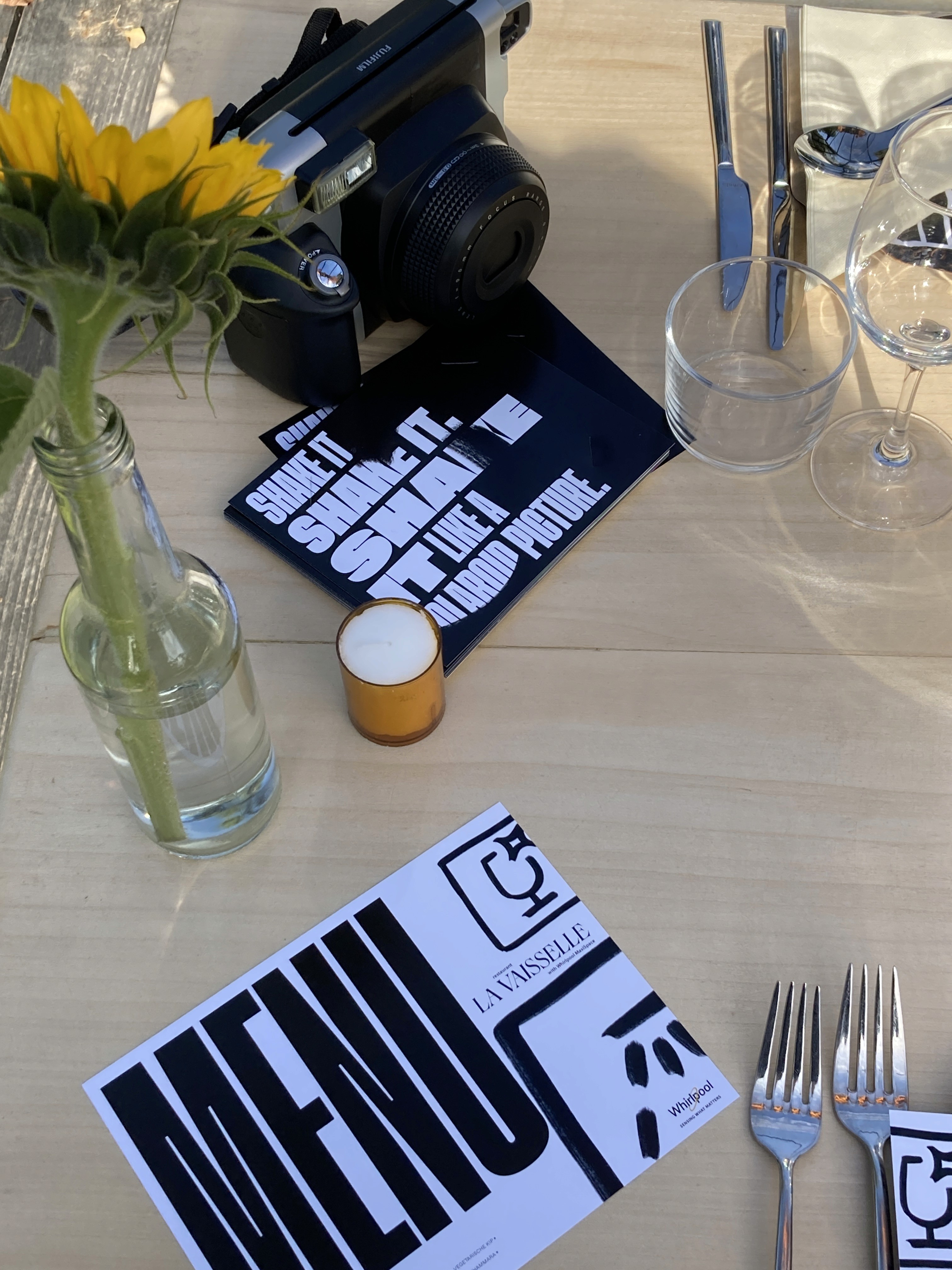 a man with headphones is focused, looking at graphs on his monitor