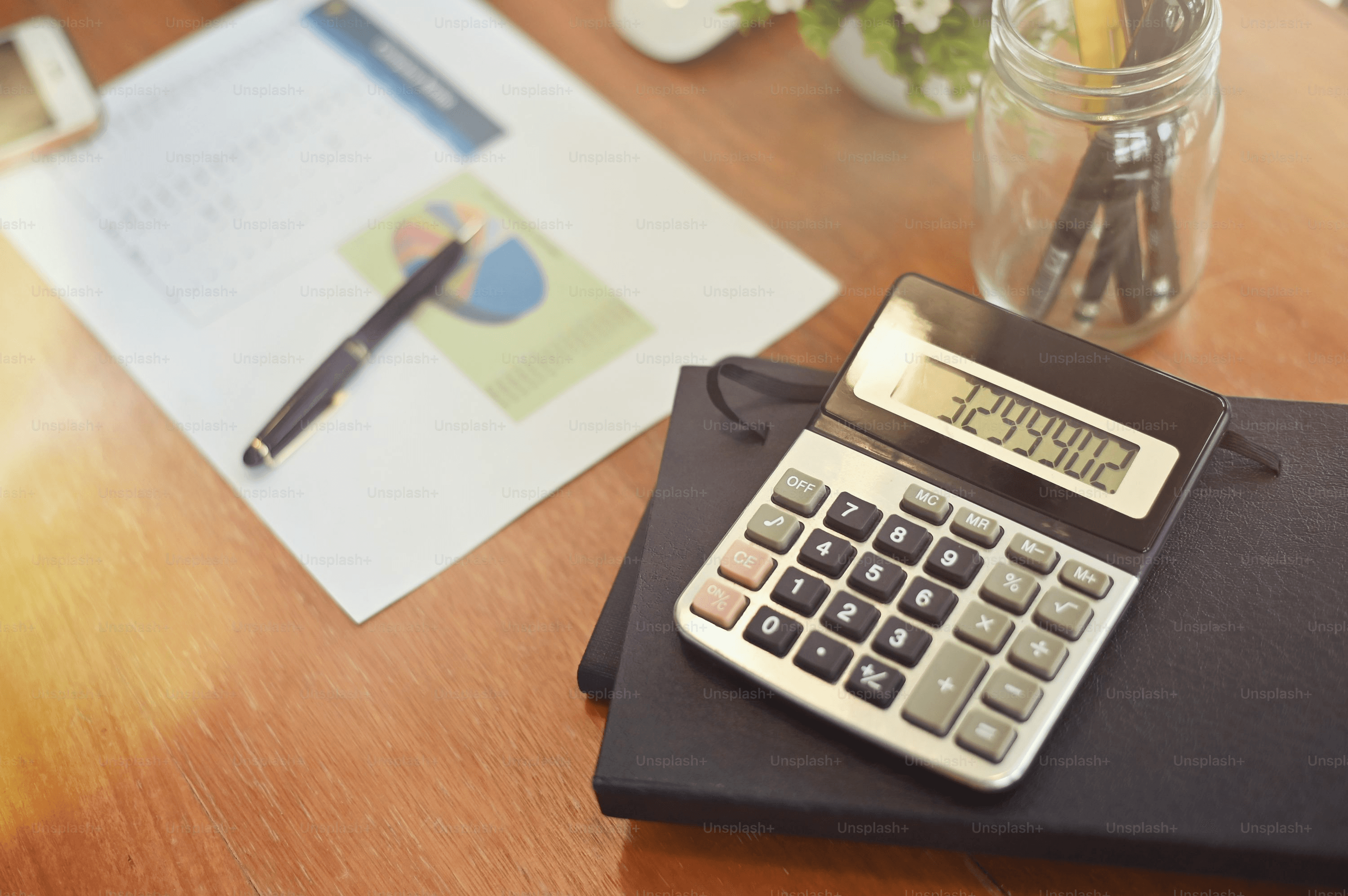 Calculator and documents on a desk during estate cost planning