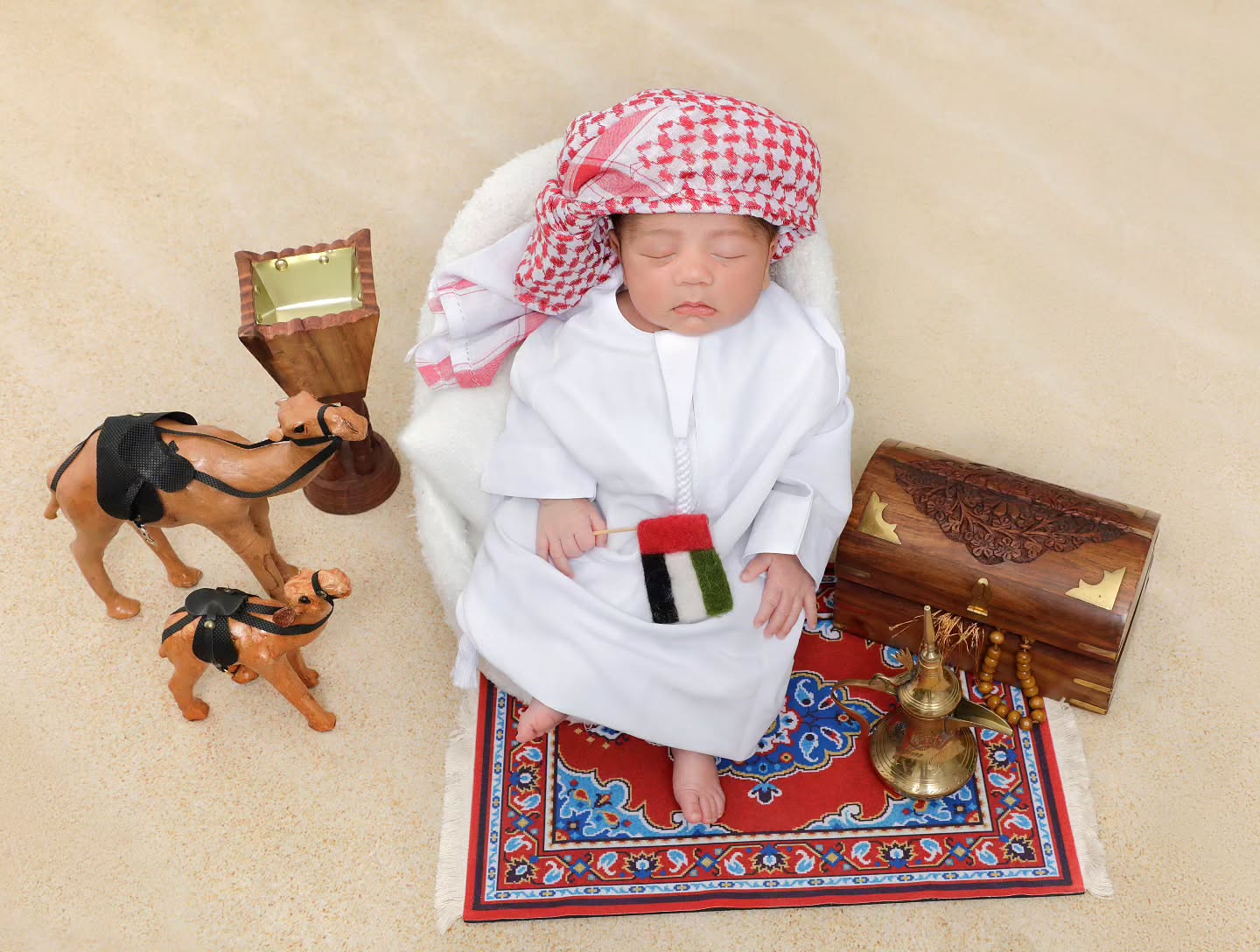 Newborn photoshoot in Dubai featuring a baby boy in traditional Arab attire, captured in a professional Mahvin Photography session