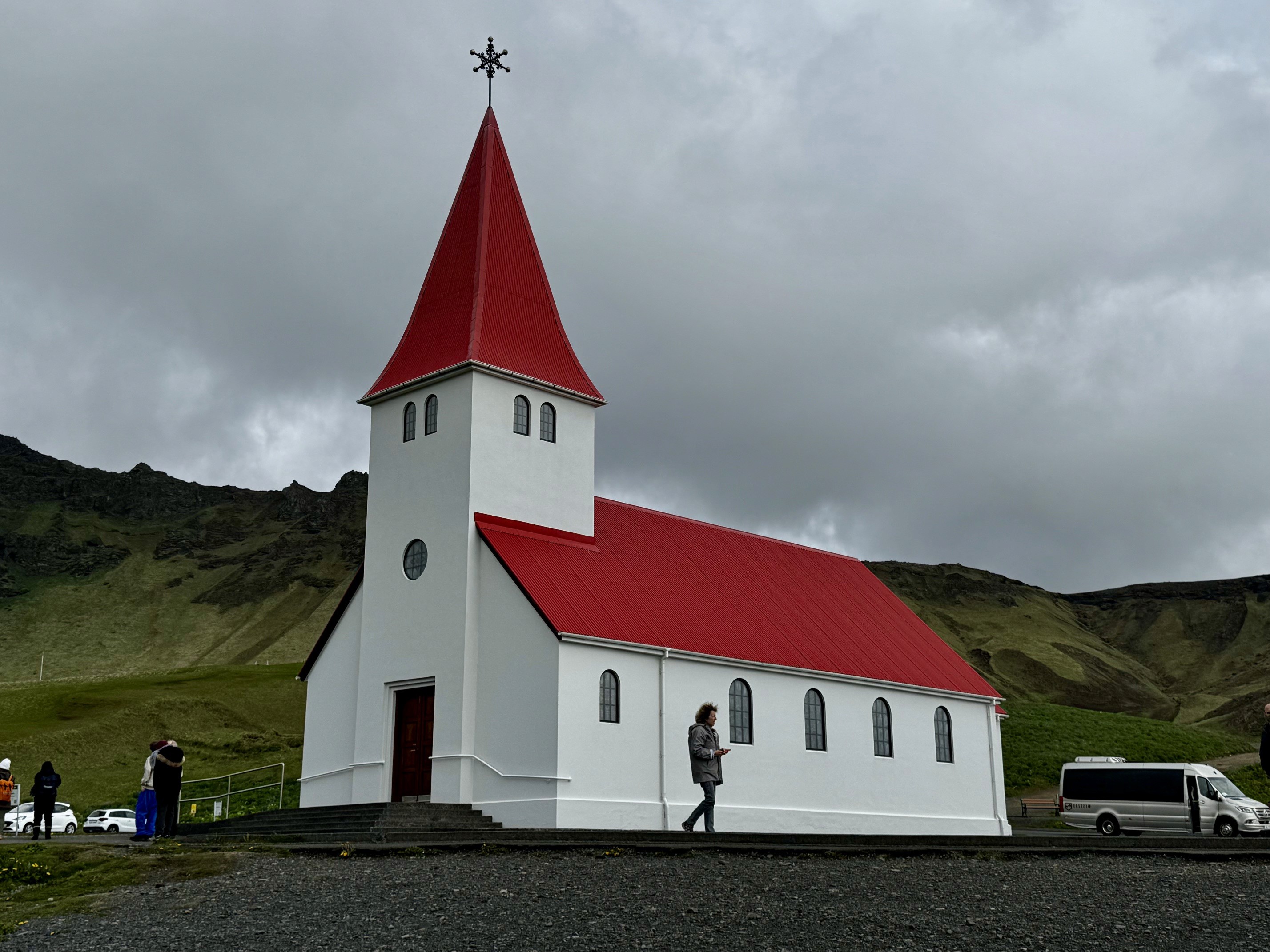 The Vík í Mýrdal Church in Vik, with a bright white walls and red roof.