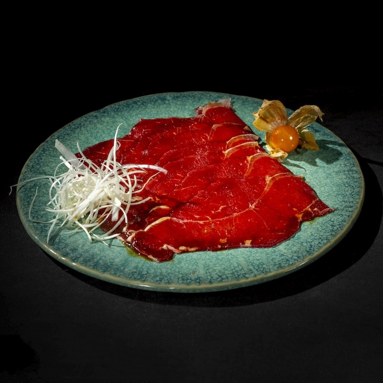 a piece of meat is being cooked on a grill