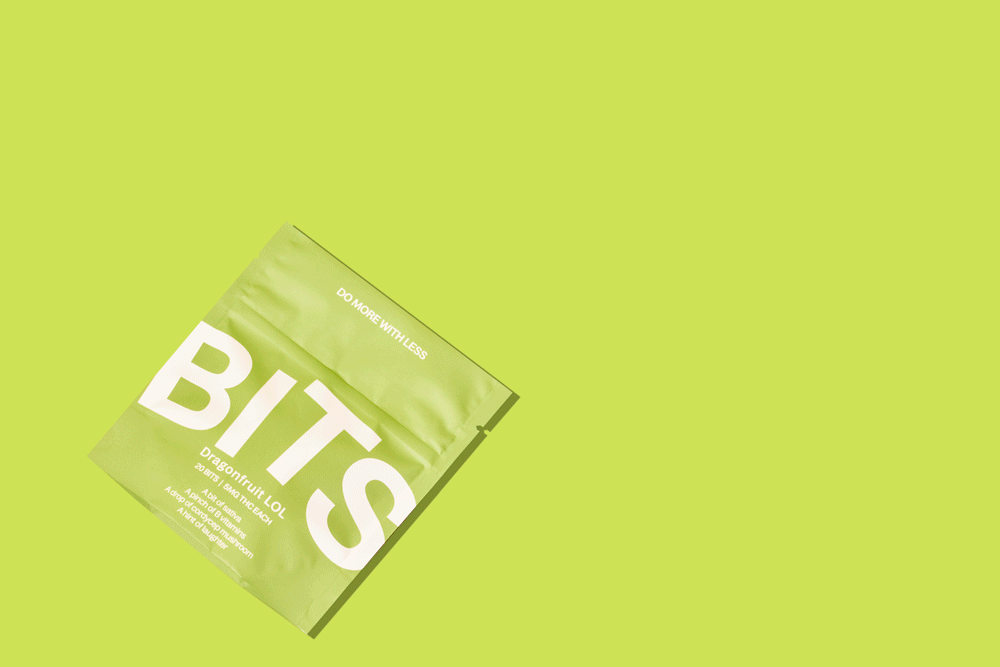 Young woman with dark hair and bangs, wearing red.