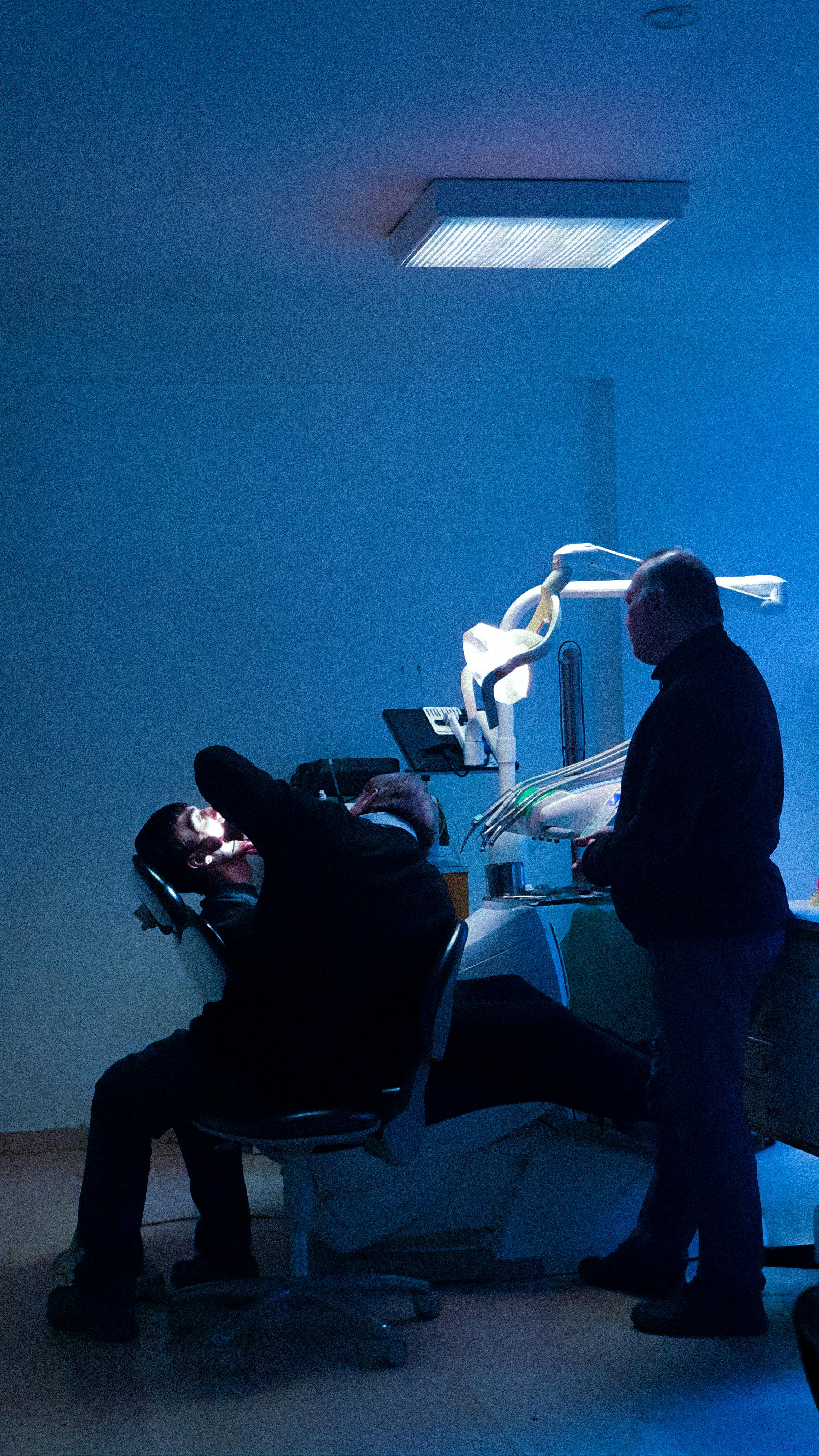 Dentist treating a patient in his dental practice